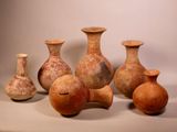 five vases sitting next to each other on a table