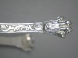 a silver spoon with a silver handle on a table