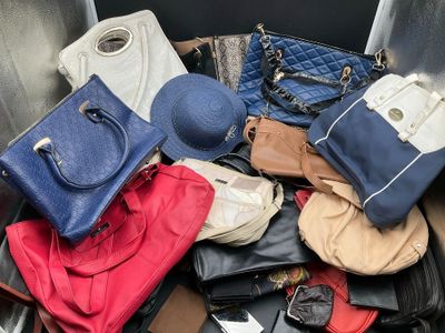 a pile of purses and hats on the ground