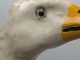 a close up of a white duck with a yellow beak