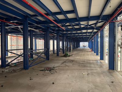 a large room with a lot of windows and a lot of scaffolding on the ceiling