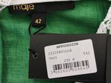 a close up of a green shirt with a label on it