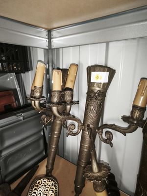 a metal candelab with candles on it in a room