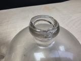 a clear glass bottle with a ring on top of it