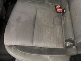 a seat in the back of a car that is dirty