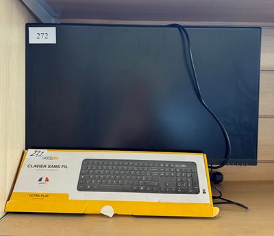 a keyboard and a monitor on a desk in front of a wall