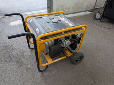 a small generator sitting on a cart in a garage