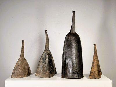 five different types of vases sitting on a white shelf