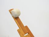 a wooden stand with a ball on top of it