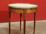 a small round table with a white top on it