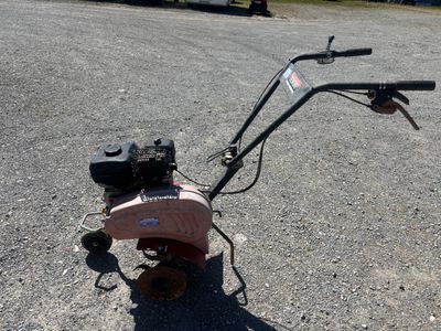 a small lawn mower that is sitting on the ground