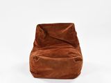 a brown bean bag chair sitting on top of a white floor