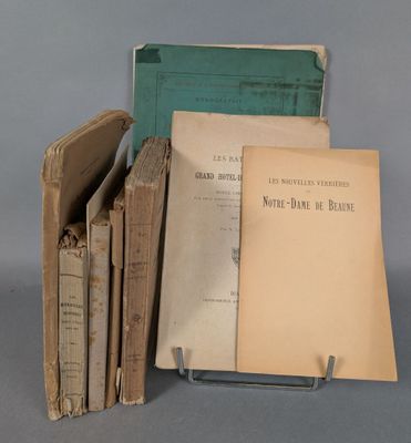 several old books are stacked on top of each other on a table