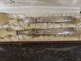 a set of silverware in a box on a table