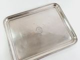 rectangular silver tray with handle on a white surface