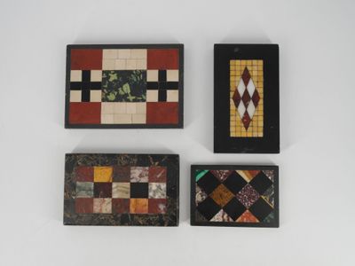 four pieces of art are displayed on a white surface