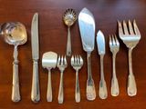 a lot of silver spoons and forks on the table