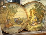 two decorative plates on display in a glass case