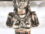 an antique silver plate with a bust of a woman on top of it
