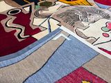 many different colored rugs that are on the floor