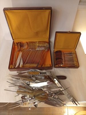 a lot of silverware in a case on a table