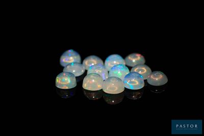 a close up of a bunch of white oplite stones on a black surface