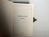 someone is holding a book in their hand and it ' s open
