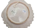 a white plate with a gold rim on a white background