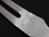 a close up of a metal fork with a metal handle