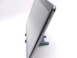 a tablet computer sitting on a stand on a white surface
