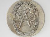 a silver coin with a masonic symbol on it