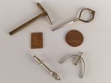 a small collection of tools that include a hammer, a hammer, a penny, a hammer, a hammer, and a hammer