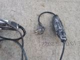 a cord connected to a car charger on the ground