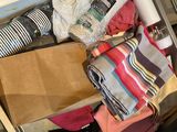 a drawer full of clothes and other items in the kitchen