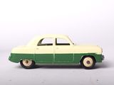 a green and white toy car on a white surface
