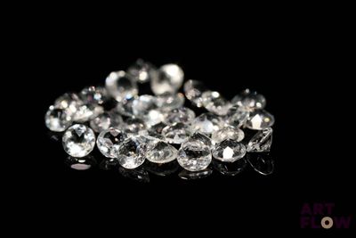 des diamants sur une surface noire avec un fond noir
