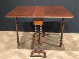 an old wooden table with two legs and a wooden top