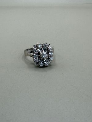 an image of a diamond ring sitting on a white surface