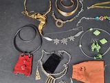 a lot of jewelry that is laying out on the table
