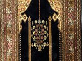 an oriental rug with a gold and black design on it