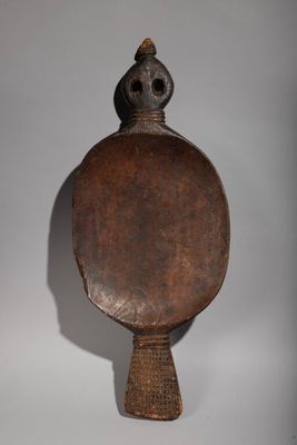 an old wooden mirror with a bird on top of it