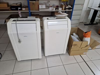 two refrigerators that are sitting in a room