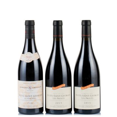three bottles of wine are lined up on a white surface