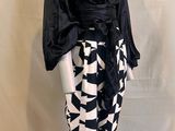 the mannequin is wearing a black and white outfit with yellow leggings