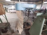 a picture of a machine in a factory with a sheet on it ' s back