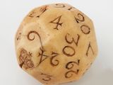 a dice with numbers written on it on a white surface