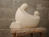 a sculpture of a man and a woman sitting on a stool
