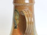 a close up of a vase with a wave on it