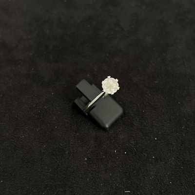 a small white flower sitting on top of a black object