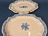 two blue and white plates with blue flowers on them on a blue surface